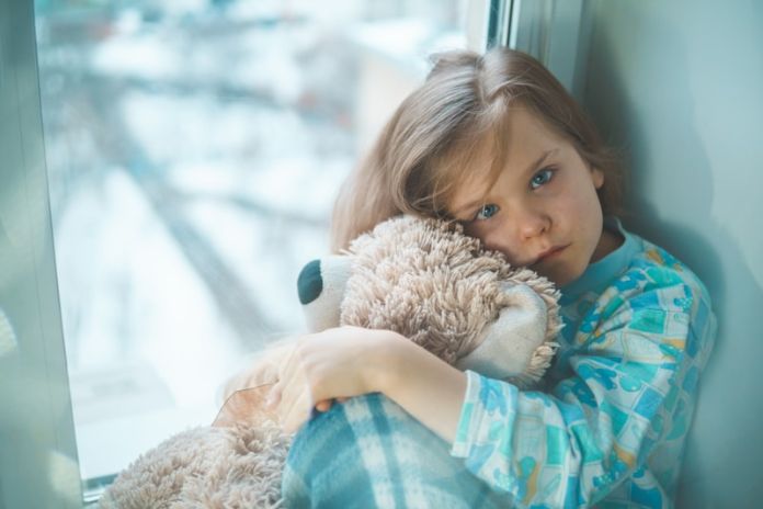 child hugs toy child